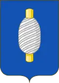D'azzurro, al fuso d'oro, bobinato d'argento.