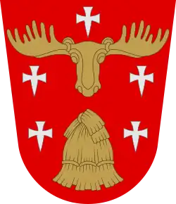 Di rosso, al covone di segale d'oro sormontato da un rincontro d'alce dello stesso, accompagnato da cinque crocette fitte d'argento, una posta in capo e due in ciascun fianco dello scudo (Hollola, Finlandia)